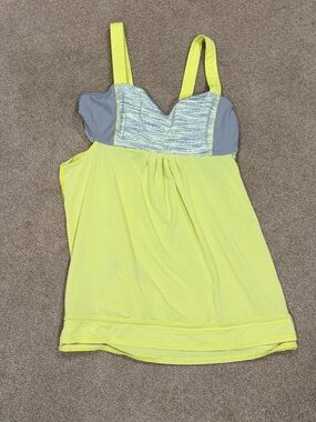 Lululemon yellow and gray workout shirt. Built in bra. Good condition. Size 8.